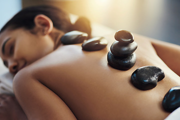 Image showing Happy woman, sleeping and hot rock massage at spa for skincare, beauty or body treatment at resort. Calm female asleep with heated rocks on back for healthy physical therapy, zen or wellness at salon