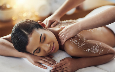 Image showing Happy woman, hands and salt scrub in back massage at spa in relax for skincare, exfoliation or body treatment. Calm female smiling in relaxation for therapy, health or zen with masseuse at salon