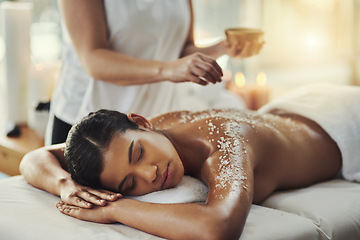 Image showing Woman, sleeping and relax in salt scrub massage at spa for skincare, exfoliation or body treatment. Calm female asleep or resting in relaxation for back therapy, health or zen with masseuse at salon