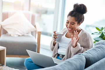 Image showing Happy woman, laptop and video call on home sofa with a smile and hand to wave hello. Real female person relax on a couch with coffee, internet connection and tech to talk online for communication