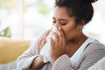 Image showing Sick, cold and a woman blowing nose on sofa with covid, virus or allergies in a house. Flu, healthy and a young lady with an allergy, sinus problem or sneezing into a tissue on the living room couch