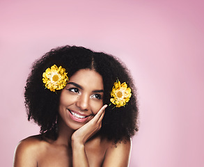 Image showing Happy woman, thinking and flowers in hair in studio, pink background and mockup for aesthetic cosmetics. Face, african model and thought with floral plants, afro and beauty ideas for natural skincare