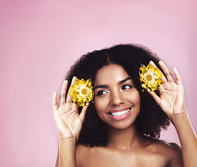 Image showing Happy woman, hair care and thinking with flowers in studio, pink background and sustainable mockup. Face, african model and daisy plants in afro to think of natural skincare, beauty ideas and makeup