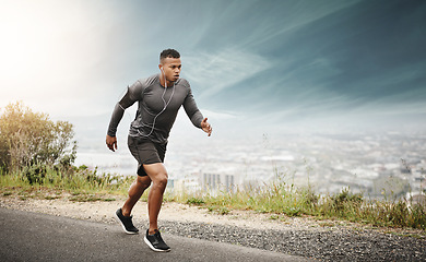 Image showing Man, runner and space in street with cityscape for exercise, wellness or music with mockup for health. African male running, listening and audio for focus, workout and outdoor with mock up on road