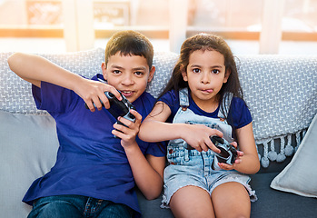 Image showing Console, portrait of children playing video games and on sofa in living room. Bonding time or happiness, technology and fun with kids or siblings with wireless remote controls on couch at their home