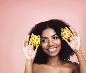 Image showing Woman, studio and thinking of flowers in hair on mockup background, floral aesthetic and sustainable choice. Happy face, african model and daisy plants in afro for beauty, ideas and natural skincare