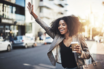 Image showing Woman, travel and hands in city for taxi, lift or street transportation with coffee outdoors. Happy female person waving hand and waiting for transport, ride or pickup on road sidewalk in urban town