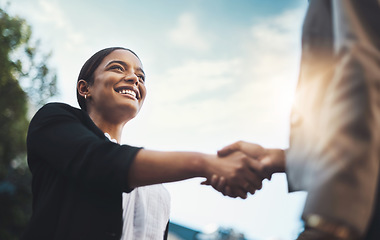 Image showing Business people, handshake and meeting in city for partnership, greeting or introduction and welcome outdoors. Happy woman with smile shaking hands for b2b, collaboration or agreement in deal outside