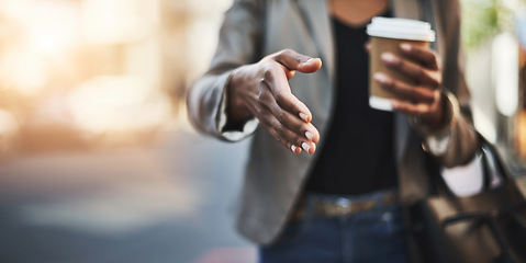 Image showing Woman, handshake and meeting in city with coffee for greeting, introduction or hiring outdoors. Hand of female shaking hands for b2b, collaboration or agreement in deal or recruitment in urban town