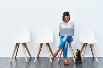 Image showing Laptop, internet and woman in interview waiting room and she search a website, connection or web sitting on chairs. Internship, work and young female person email online ready for a new job