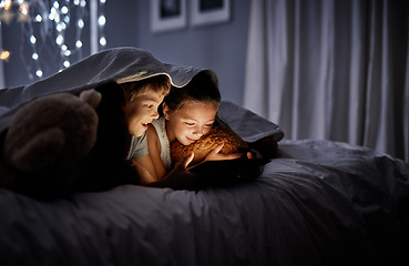 Image showing Night, bedroom and siblings with a tablet, online games and bonding with fun, happiness and relax. Children, brother or sister with technology, movies and films with development, home and bed time