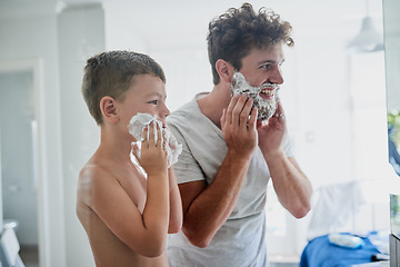 Image showing Father, child and teaching how to shave in bathroom, having fun or bonding together. Smile, kid learning and dad shaving cream on face, playing and cleaning, hygiene and enjoying quality time in home