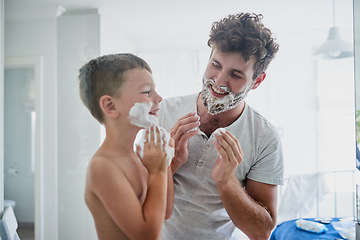 Image showing Father, child and teaching how to shave in bathroom, having fun or bonding together. Smile, kid learning and dad shaving cream on face, playing and cleaning, hygiene and enjoying quality time in home