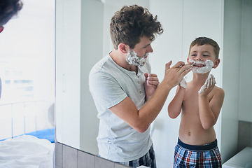 Image showing Father, child and learning to shave in bathroom, having fun or bonding together. Smile, dad and teach kid with shaving cream on face, playing or cleaning, hygiene or enjoying hair removal with care.