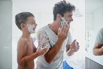 Image showing Kid, father and learning to shave, laughing and bonding together in bathroom. Funny, dad and teaching child with shaving cream on face beard, playing or cleaning, hygiene or enjoying hair removal.