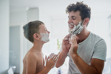 Image showing Kid, father and learning to shave, funny or bonding together in home bathroom. Laughing, dad and teaching child with shaving cream on face beard, playing or cleaning, hygiene or enjoying hair removal