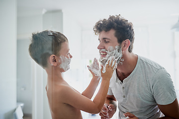 Image showing Child, father and learning to shave, smile and bonding together in home bathroom. Happy, dad and teaching kid with shaving cream on face beard, playing or cleaning, hygiene or enjoying hair removal.