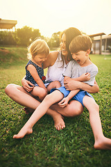 Image showing Mother, happy children or hug playing on grass for fun bonding in summer outside a house in nature. Funny mom hugging playful kids siblings on garden playground with happiness of family together