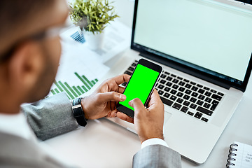 Image showing Phone, green screen and man hands on laptop for mobile app mockup, data analytics and website design. Multimedia, technology and business person with smartphone mock up or space in office advertising