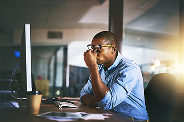 Image showing Black business man, stress and fatigue in night, office and headache by computer for project deadline. African businessman, burnout or anxiety in workplace by pc, web design startup and mental health