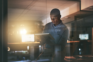 Image showing Black business man, night and tablet with reading, planning or focus for deadline, research or project. African businessman, digital touchscreen and web design with ux, website or typing in workplace