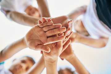 Image showing Low angle, partnership and close up of hands or group of siblings in solidarity or team together and on bokeh outdoors. Trust, stacked palms and brothers or sisters or children playing outside focus