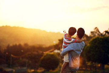 Image showing Father, child and pointing to sunset in nature for travel, holiday or weekend getaway outdoors. Back of dad holding kid enjoying the future, sunrise or horizon for family bonding on mockup space