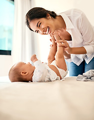 Image showing Happy, love and a mama with her baby in the bedroom of their home together for playful bonding. Family, children and a young mother spending time with her newborn infant on the bed for fun or joy