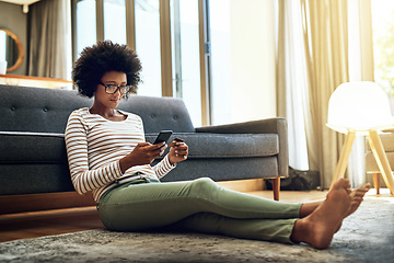 Image showing Black woman, phone and credit card in living room for ecommerce, payment or purchase at home. African female person or shopper sitting on floor with smartphone or debit for online shopping or banking