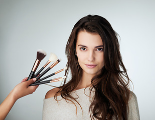 Image showing Woman, beauty and makeup brush for face in studio with a natural glow. Portrait of female person on a grey background with a hand for cosmetology transformation, powder cosmetics and facial skin care