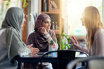 Image showing Friends, smile and Muslim women in cafe, bonding and talking together. Coffee shop, happy and Islamic girls, group or people in conversation, chat and discussion for social gathering in restaurant.