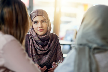 Image showing Conversation, friends and Muslim women in cafe, bonding and speaking together. Coffee shop, relax and Islamic girls, group or people talking, chat and discussion for social gathering in restaurant