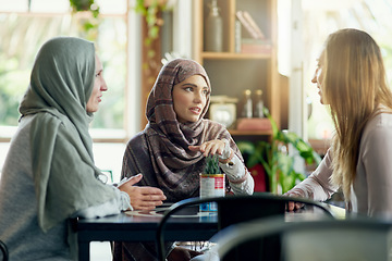 Image showing Friends, talking and Muslim women in cafe, bonding and speaking together. Coffee shop, relax and Islamic girls, group or people in conversation, chat and discussion for social gathering in restaurant