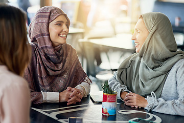 Image showing Friends, funny and Muslim women in cafe, bonding and talking together. Coffee shop, happy and Islamic girls, group or people laughing, conversation and discussion for social gathering in restaurant.