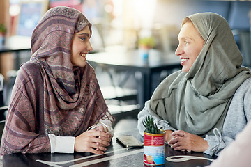 Image showing Friends, happy and Muslim women in cafe, bonding and talking together. Coffee shop, relax and Islamic girls, group or people chat, conversation and discussion for social gathering in restaurant.