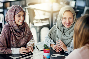 Image showing Happy, friends and Muslim women in coffee shop, bonding and talking together. Cafe, relax and Islamic girls, group or people chatting, conversation and discussion for social meeting in restaurant.