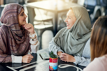 Image showing Smile, friends and Muslim women in coffee shop, bonding and talking together. Cafe, relax and Islamic girls, group or people chat, conversation and discussion for social gathering in restaurant.