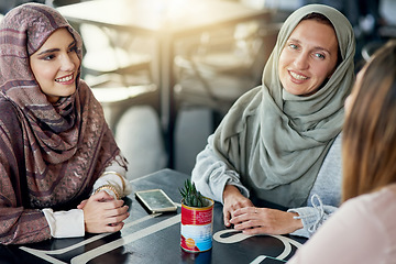 Image showing Friends, relax and Muslim women in coffee shop, bonding and talking together. Cafe, happy and Islamic girls, group or people chatting, conversation and discussion for social meeting in restaurant.