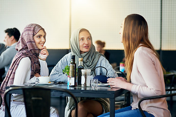 Image showing Friends, smile and Muslim women in cafe, bonding and talking together. Coffee shop, happy and Islamic girls, group or people chat, conversation and discussion for social gathering in restaurant.