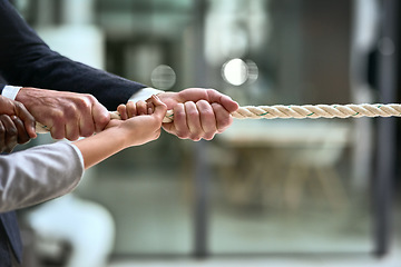 Image showing Hands, teamwork and rope with business people pulling during a game of tug of war in the office. Collaboration, help and strength with a team of employees or colleagues holding onto an opportunity