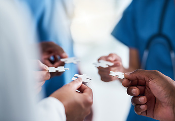 Image showing Hands, puzzle and teamwork of doctors in hospital for team building, synergy and planning. Collaboration, nurses and jigsaw pieces for healthcare, medical solution and strategy, cooperation and trust