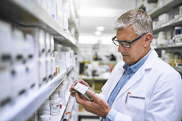 Image showing Pharmacy, medicine and check with man at shelf in drug store for label, inspection and inventory. Medical, healthcare and pills with male pharmacist in clinic for expert, wellness and product check