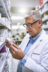 Image showing Pharmacy, medicine and reading with man at shelf in store for inspection, search and inventory. Medical, healthcare and pills with senior male pharmacist in clinic for expert, wellness and product