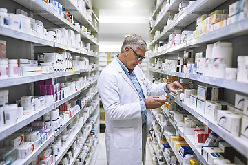 Image showing Pharmacy, medicine and search with man at shelf in drug store for thinking, inspection and inventory. Medical, healthcare and pills with senior male pharmacist for expert, wellness and product