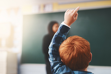 Image showing Hand, student and child in classroom with question for teacher, education and learning with school blackboard. Boy, raise arm and questions for knowledge, information and development in class