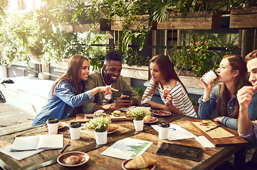 Image showing Teamwork, restaurant and business people in meeting with phone for internet, social networking and website. Coffee shop, lunch and men and women chatting for discussion, planning and strategy
