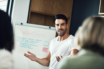 Image showing Presentation meeting, whiteboard and man explain strategy, business plan or brainstorming ideas, coaching or teaching team. Group mentor, coach or startup leader speaking to creative design staff