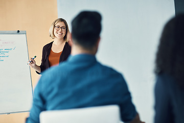 Image showing Presentation meeting, seminar speech and happy woman talking to tradeshow, sales team or investment clients. Event presenter, whiteboard and female business leader chat to listening conference group