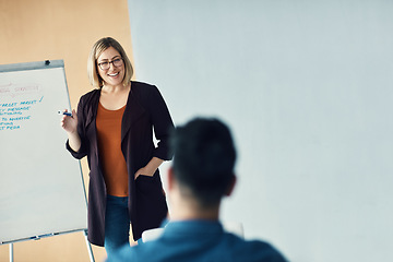 Image showing Presentation whiteboard, team meeting speech and happy woman talking to trade show, sales group or investment clients. Strategy planning, report and person speaking to listening conference people