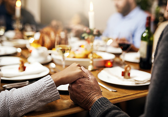 Image showing Closeup, thanksgiving and hand holding with family at table in dining room for holiday, food or worship. Celebration, support and gratitude with people praying at home for kindness, dinner and love